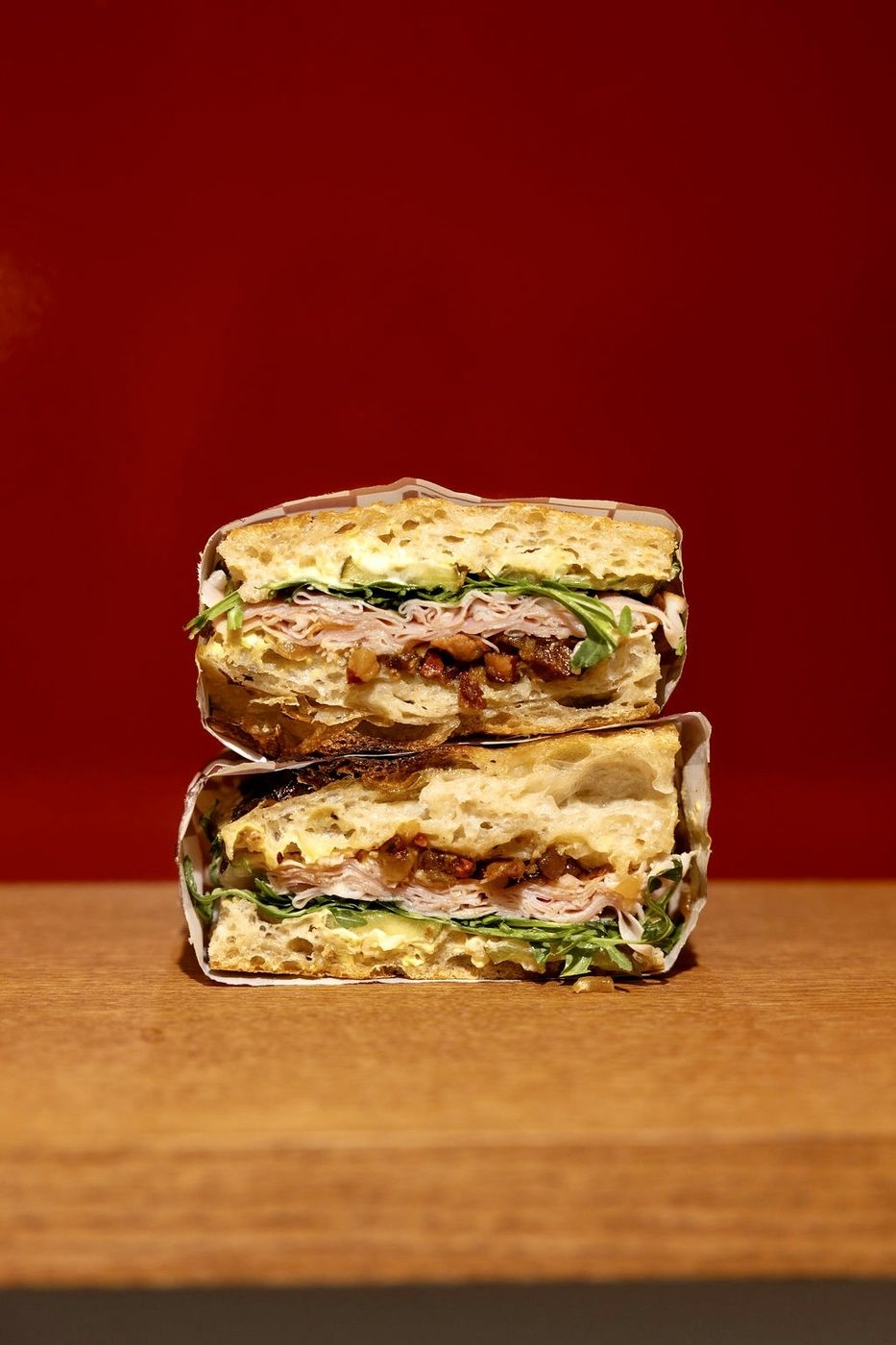 Two Rosèl sandwiches stacked on a wooden counter