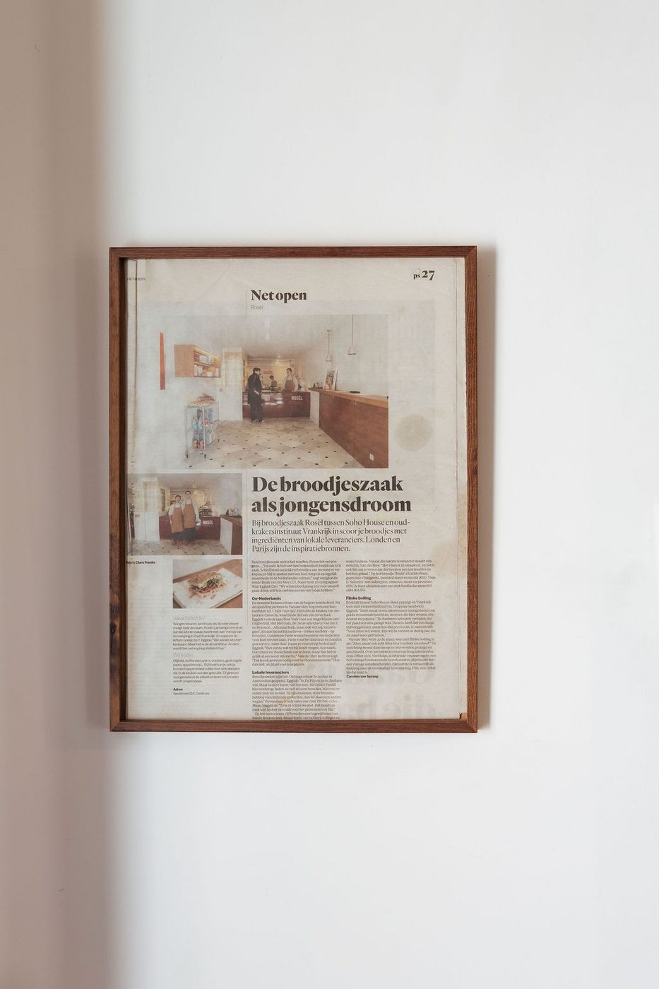 A framed newspaper article about Rosèl on the wall